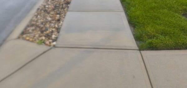 This concrete washing project in Middle Valley revived a driveway, front walkway, and back patio by treating mold and dirt with professional-grade detergents followed by a thorough, methodical power rinse.