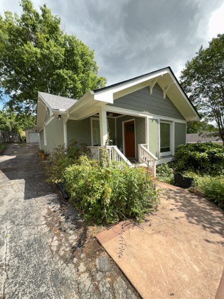 This project involved a comprehensive soft wash cleaning of a one-story residence, metal garage, and wood deck in Chattanooga to remove organic growth and dirt while preserving the integrity of all exterior surfaces.