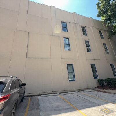 This project involved a comprehensive exterior soft wash and concrete power washing of a commercial property in Chattanooga, utilizing a 60-foot manlift to safely and thoroughly clean the building's masonry, sidewalks, stairs, and roof.