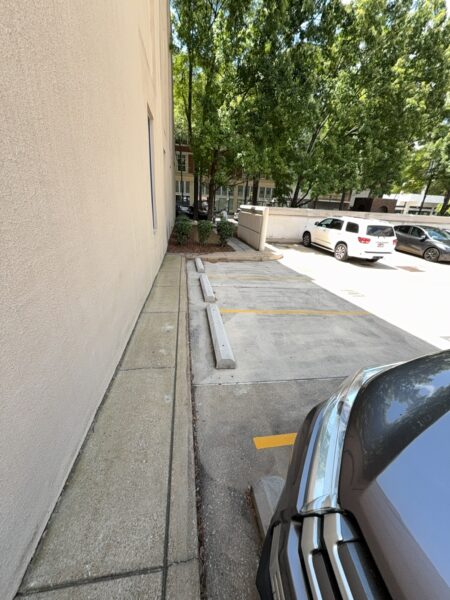 This project involved a comprehensive exterior soft wash and concrete power washing of a commercial property in Chattanooga, utilizing a 60-foot manlift to safely and thoroughly clean the building's masonry, sidewalks, stairs, and roof.
