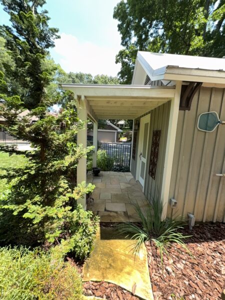 This project involved a comprehensive exterior refresh of a Chattanooga home using soft washing and surface cleaning to safely remove dirt, mold, and residue from the siding, gutters, porches, concrete walkways, brick retaining walls, entryway columns, wooden swing, and stone pool deck.