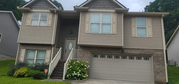 This project involved a comprehensive exterior refresh of a two-story Chattanooga home, including a soft-wash house cleaning with a mold warranty, a driveway concrete wash, gutter debris removal, and exterior window cleaning to restore both curb appeal and functionality.