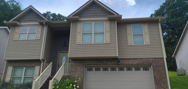 This project involved a comprehensive exterior refresh of a two-story Chattanooga home, including a soft-wash house cleaning with a mold warranty, a driveway concrete wash, gutter debris removal, and exterior window cleaning to restore both curb appeal and functionality.