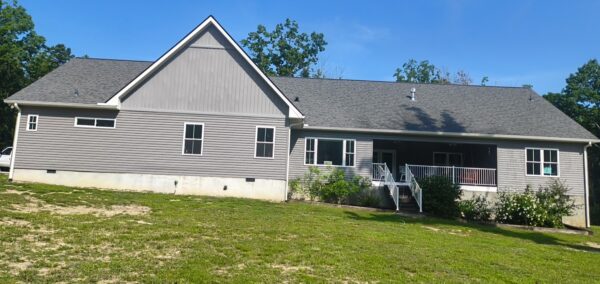 This project involved a comprehensive exterior soft wash of a one-story residence in Rising Fawn to remove organic buildup and meet a one-year mold warranty, alongside a detailed concrete cleaning of the front walkway and garage pad using pre-treatment and a surface washer.