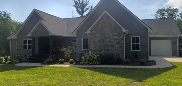 This project involved a comprehensive exterior soft wash of a one-story residence in Rising Fawn to remove organic buildup and meet a one-year mold warranty, alongside a detailed concrete cleaning of the front walkway and garage pad using pre-treatment and a surface washer.