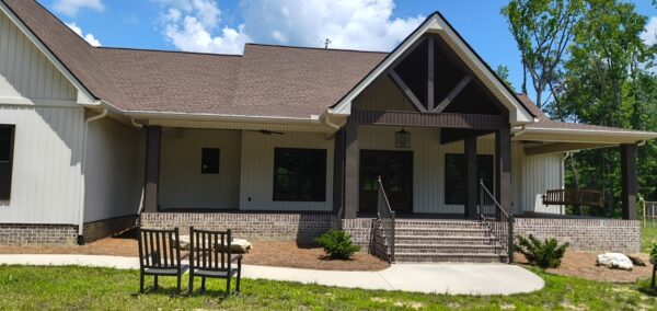 A complete exterior soft wash was performed on a one-story residence in Rising Fawn, thoroughly cleaning the soffits, fascia, gutters, downspouts, and siding using a low-pressure system and gentle agitation to safely remove organic growth and dirt.