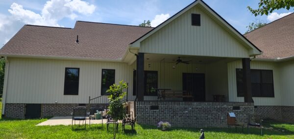 A complete exterior soft wash was performed on a one-story residence in Rising Fawn, thoroughly cleaning the soffits, fascia, gutters, downspouts, and siding using a low-pressure system and gentle agitation to safely remove organic growth and dirt.