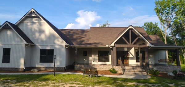 A complete exterior soft wash was performed on a one-story residence in Rising Fawn, thoroughly cleaning the soffits, fascia, gutters, downspouts, and siding using a low-pressure system and gentle agitation to safely remove organic growth and dirt.