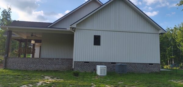 A complete exterior soft wash was performed on a one-story residence in Rising Fawn, thoroughly cleaning the soffits, fascia, gutters, downspouts, and siding using a low-pressure system and gentle agitation to safely remove organic growth and dirt.