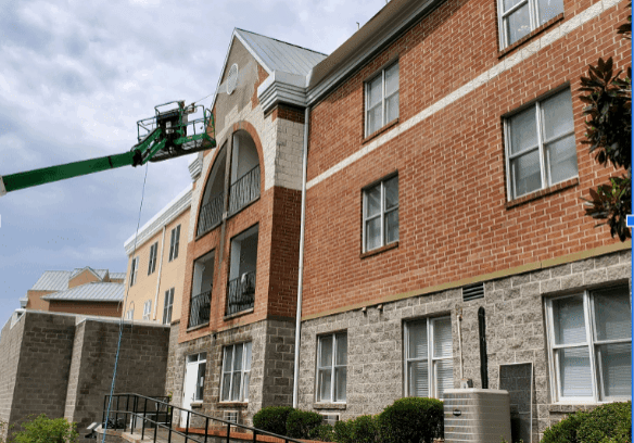 Actively cleaning apartments on a lift in chattanooga tn by qualitypro power washing