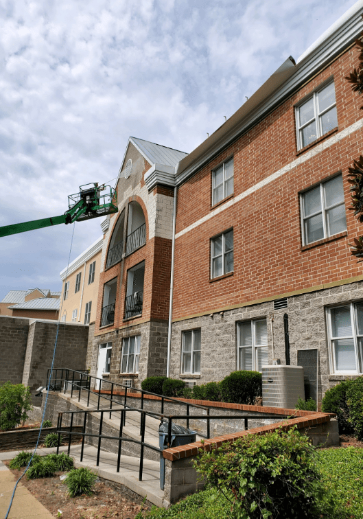 Actively cleaning apartments on a lift in chattanooga tn by qualitypro power washing